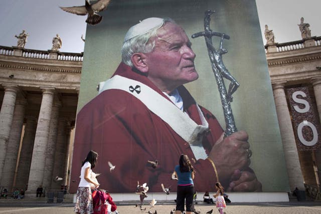 A photo of the late Pope John Paul II hanging from a stage set up near St Peter's Square in Rome