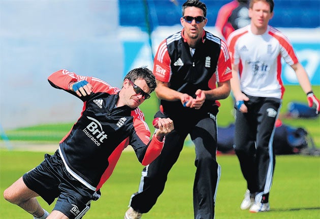 England's Eoin Morgan and Kevin Pietersen look on as James Anderson juggles a catch during practice at Sophia Gardens in Cardiff
