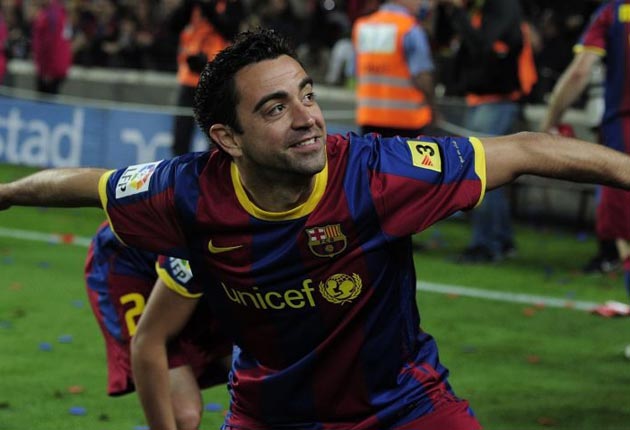 Xavi (above) said Cesc Fabregas was 'suffering' because he was not being allowed to join Barcelona