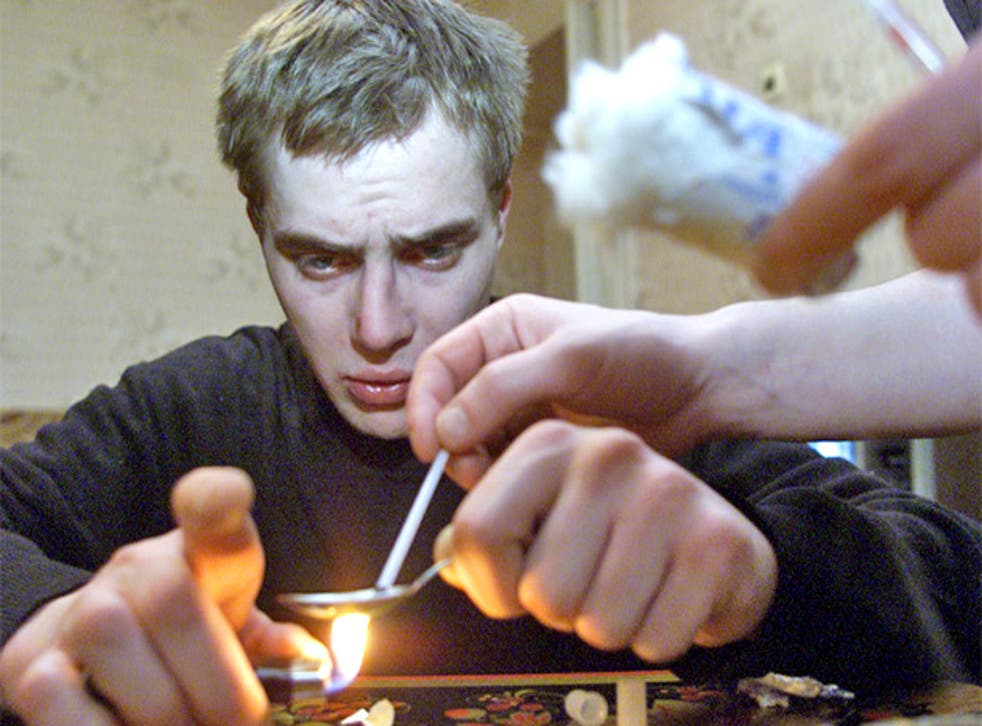 A heroin user prepares the drug in Zhukovsky, near Moscow