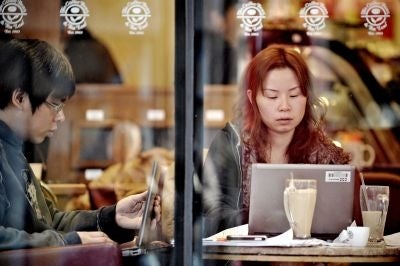 People surf the internet using free wi-fi at a cafe in Shanghai