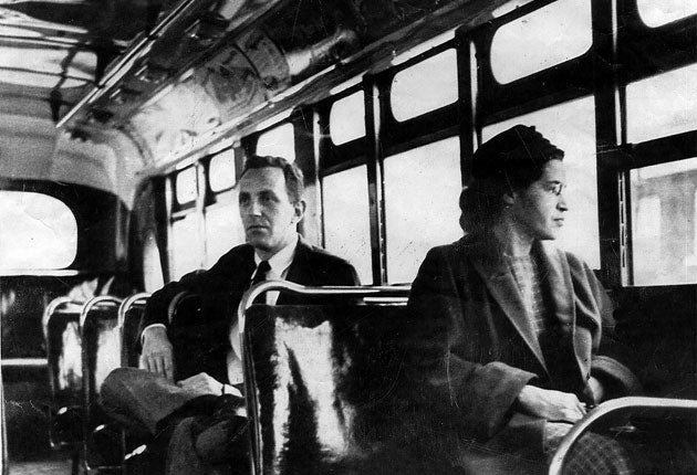 Rosa Parks riding on a bus in Alabama in 1955, the act of defiance that led to the civil rights movement