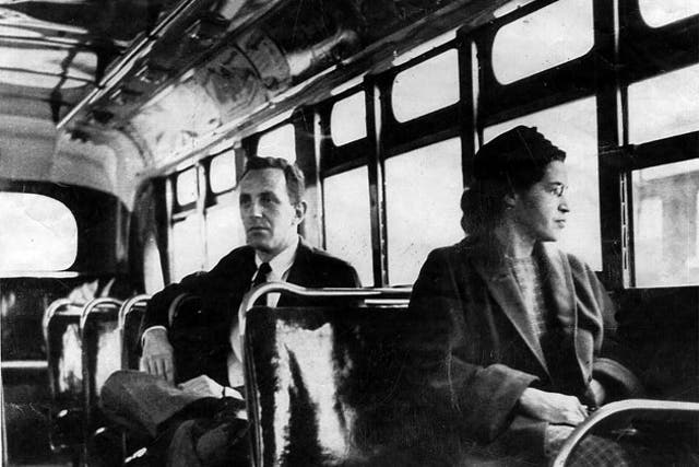 Rosa Parks riding on a bus in Alabama in 1955, the act of defiance that led to the civil rights movement