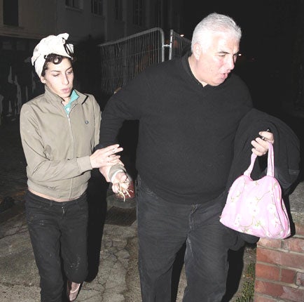 Amy Winehouse with her father, Mitch, leaving her flat in Camden, north
London, in 2008