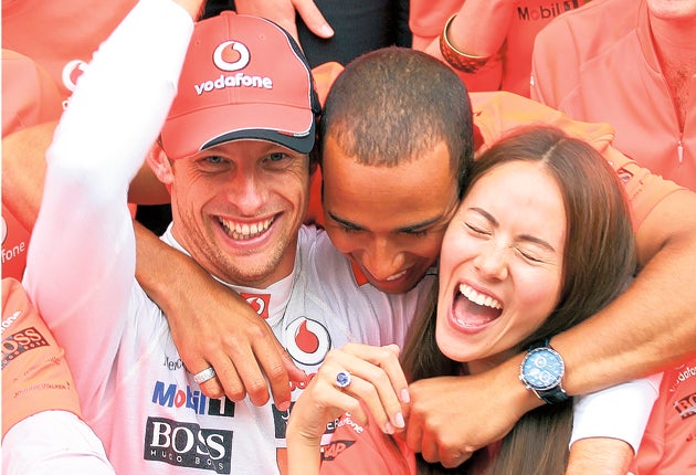 Jenson Button celebrates with his team-mate Lewis Hamilton and girlfriend Jessica Michibata