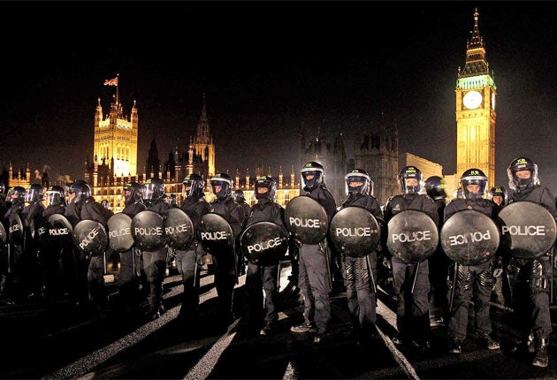 Kettle on: Police officers in riot gear contain student protesters on Westminster Bridge in December 2010