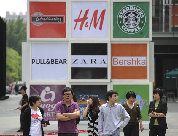 Land of delusions: Beijing shoppers in front of billboards