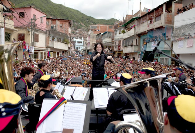 Lightning conductor: Gustavo Dudamel and the Simon Bolivar Symphony Orchestra play in La Vega, a poor area of Caracas, the capital of Venezuela