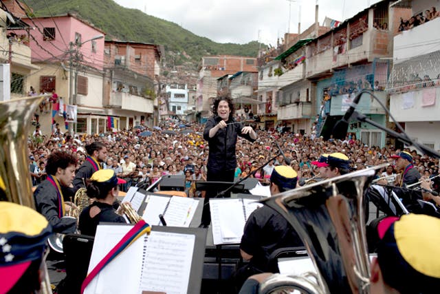 Lightning conductor: Gustavo Dudamel and the Simon Bolivar Symphony Orchestra play in La Vega, a poor area of Caracas, the capital of Venezuela