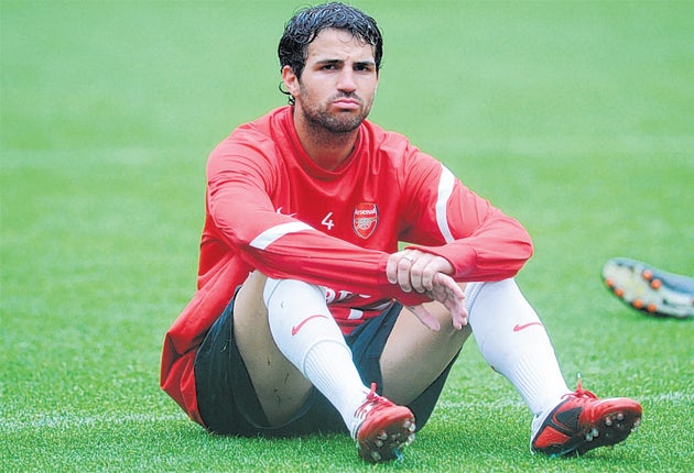 Cesc Fabregas looks lost in thought at Arsenal's training session yesterday