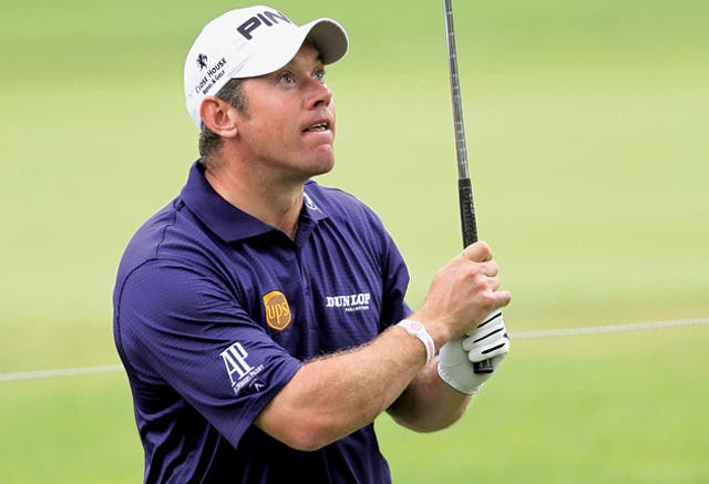 Lee Westwood keeps a close eye on his second shot from the rough on the 10th hole