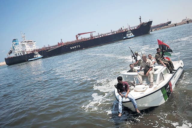 Rebels escort the tanker Cartagena yesterday, which was on its way to Tripoli