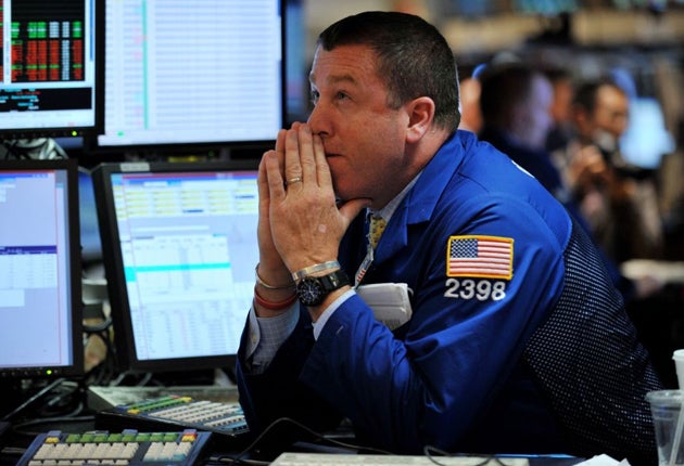 A worried trader on the floor of the New York Stock Exchange