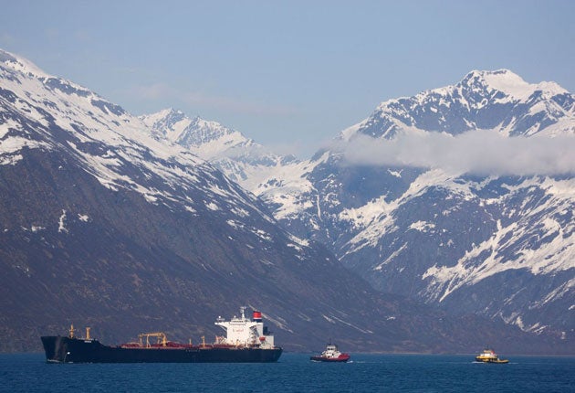 An oil tanker escorted by two tugs off the coast of Alaska