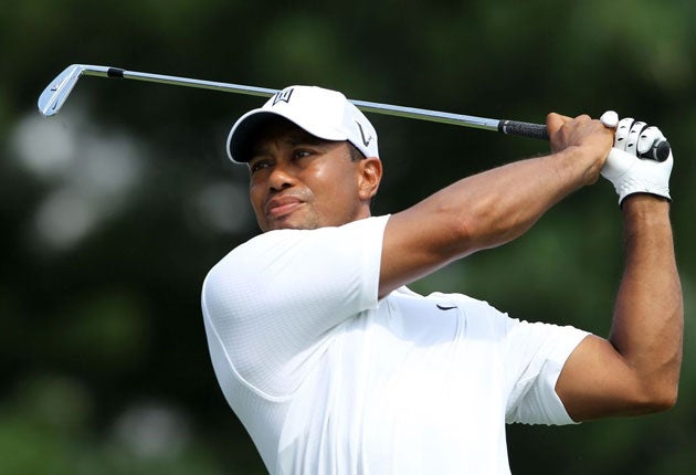 Tiger Woods hits his tee shot at the 17th on the way to one of his four
birdies in a one-over 71 at Firestone yesterday