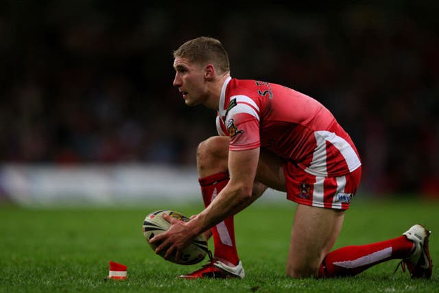 Kneel and play: Sam Tomkins controlled the game for Wigan against St Helens