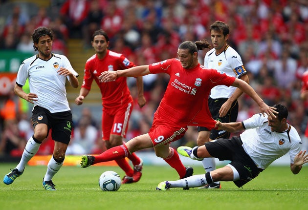 Power play: Andy Carroll causes panic in the Valencia defence with another forceful display during Liverpool's 2-0 victory in their friendly match at Anfield