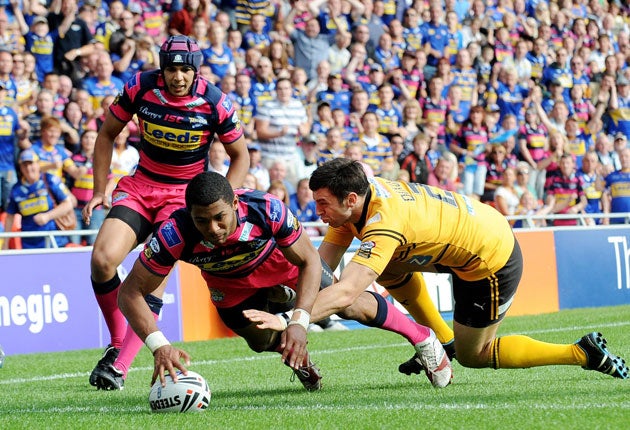 Leeds' Kallum Watkins beats Kirk Dixon, of Castleford, to score