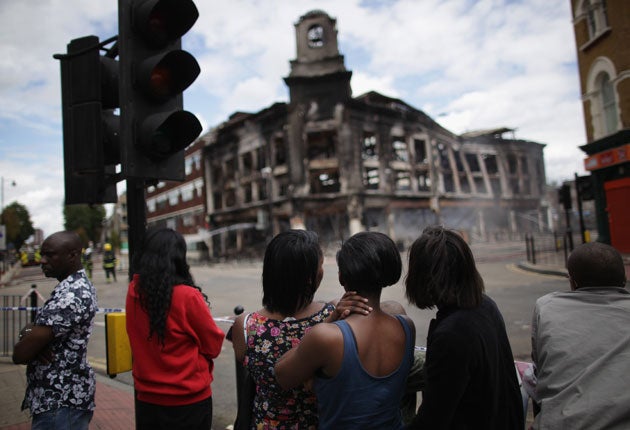 Residents survey the damage in Tottenham High Road
