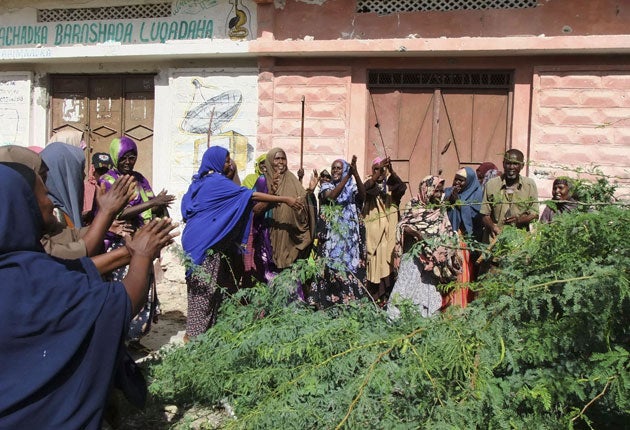 Somali women prepare to clean the Mogadishu streets left empty by al-Shabaab after the Islamist fighters withdrew from almost all their bases in the city