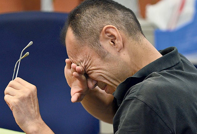 A trader in Tokyo reacts on a stressful day for markets around the world