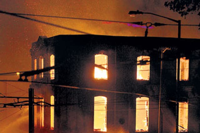 A property burns near Reeves Corner, Croydon, during the riot last night
