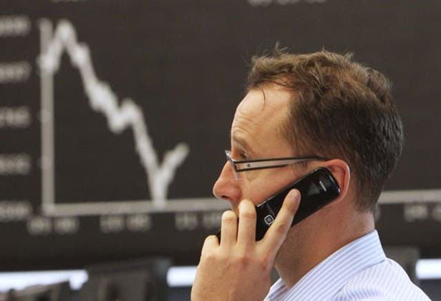 A broker makes a phone call at the stock market in Frankfurt
