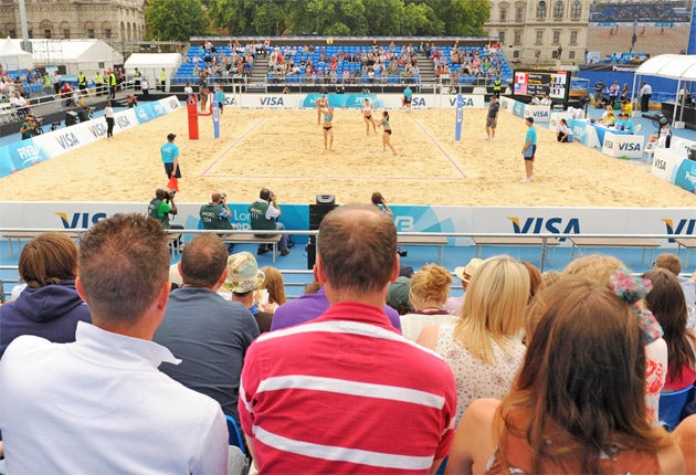 The crowd watch the beach volleyball at Horse Guards yesterday as London turns into a city of two halves