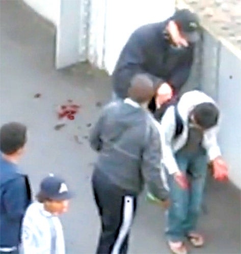 The mob that showed no mercy: A video uploaded to YouTube last night shows a young boy who is bleeding profusely being mugged by a group of youths who had at first seemed to be helping him. Among the most shocking footage to circulate in the aftermath of Monday night's riots, it was captured by a resident of Queens Road in Barking, east London, and shows a group of masked youths surrounding the boy while he bleeds on the floor. One appears to help the boy to his feet, while another opens his rucksack and removes items from it, leaving the scene with a swagger. The victim's identity and condition are unknown.