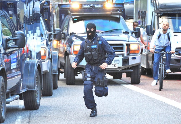 A special forces police officer runs to deal with the unrest in Hackney on Monday