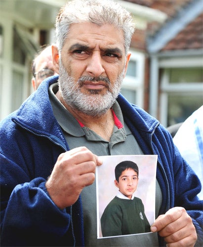 Grieving father, Tariq Jahan, holds a picture of his son Haroon Jahan