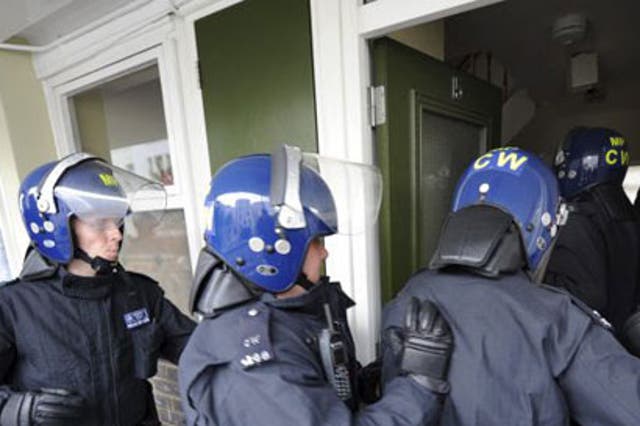 Police officers raid a property in Pimlico, London