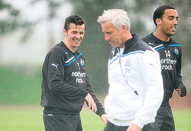 Newcastle's Joey Barton (left) is all smiles during a training session with the manager Alan Pardew yesterday