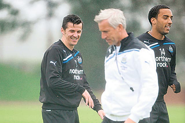 Newcastle's Joey Barton (left) is all smiles during a training session with the manager Alan Pardew yesterday