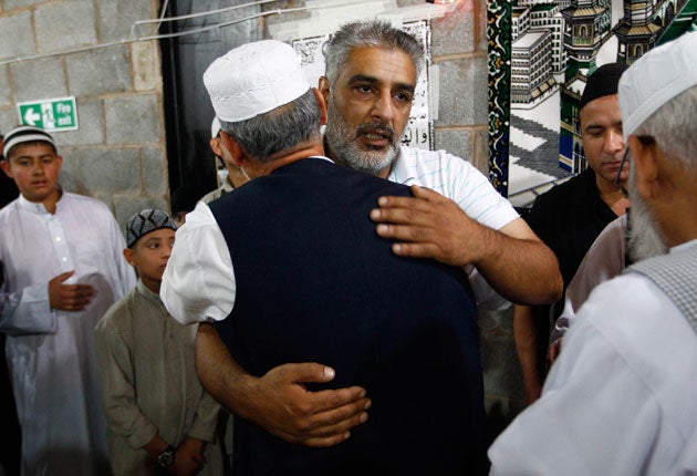 Tariq Jahan, father of Haroon, is consoled by worshippers at his
mosque in Birmingham