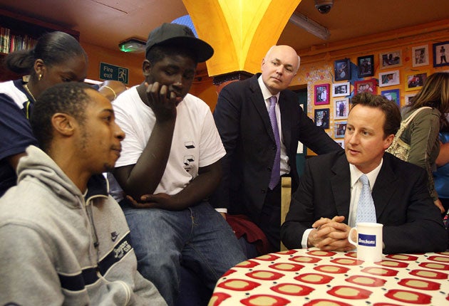 Talking point: Iain Duncan Smith, centre, with David Cameron and two youths in London