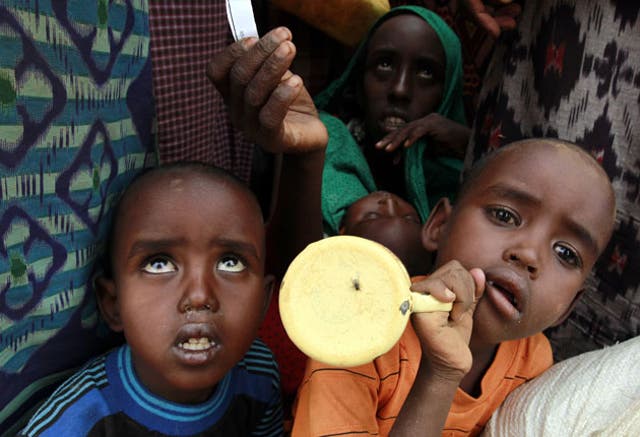 Somali children wait outside one of the four refugee camps established along Ethiopia's border with Somalia. Water rations have dropped from 10 litres a day per person to three