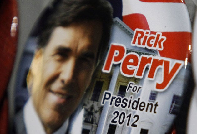 'Rick Perry for President' buttons were on show at the Republicans' summer dinner in Birmingham, Alabama, on Friday
