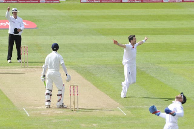 James Anderson celebrates after Matt Prior catches Rahul Dravid to give him his third wicket of the innings and draw level with Sir Alec Bedser on the all-time England list