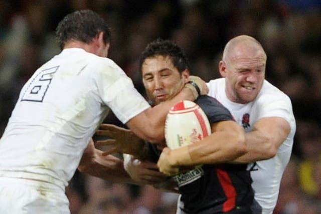 Gavin Henson is tackled by England's Tom Wood and Mike Tindall on Saturday