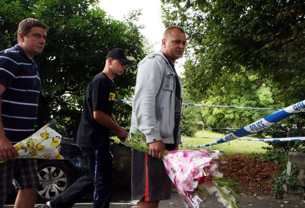 Friends of the victims leave flowers at Victoria Crescent in St Helier