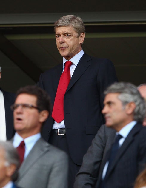 Wenger was forced to watch last night's match from the stands