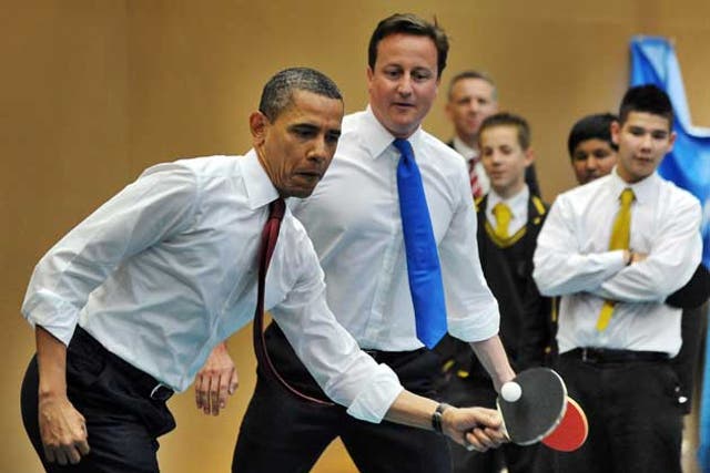 Obama and Cameron play table tennis with students of the Globe Academy school in London