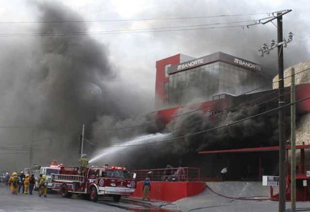 Fire crews try to extinguish the fire in Monterrey