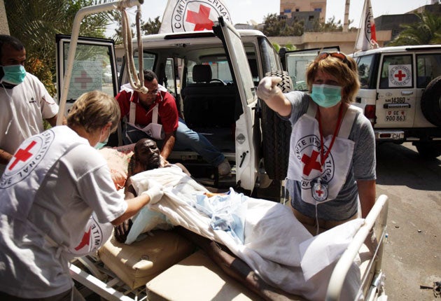 International Committee of the Red Cross workers evacuate injured people from the Abu Salim hospital in Tripoli