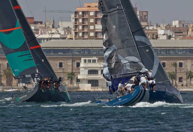 With a damaged wing slowing them, Italy's Azzurra (right) can do nothing to stop America's Quantum marching past to win the coastal race in the AudiMedCup off Cartagena, Spain