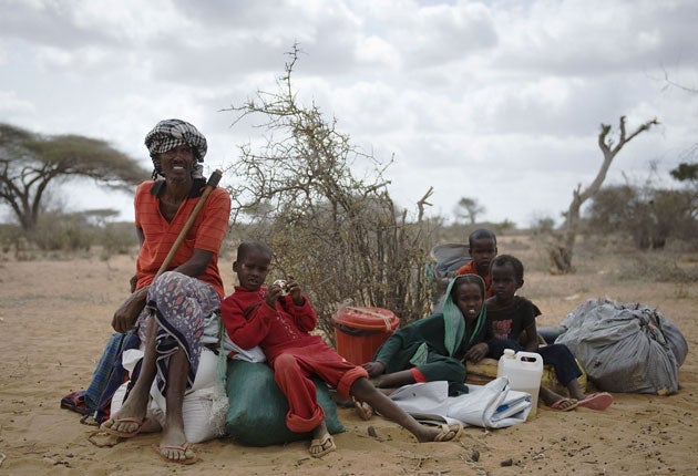 A refugee family waits to move into a new settlement at the Dadaab camp, in Kenya, where the population has grown to 400,000