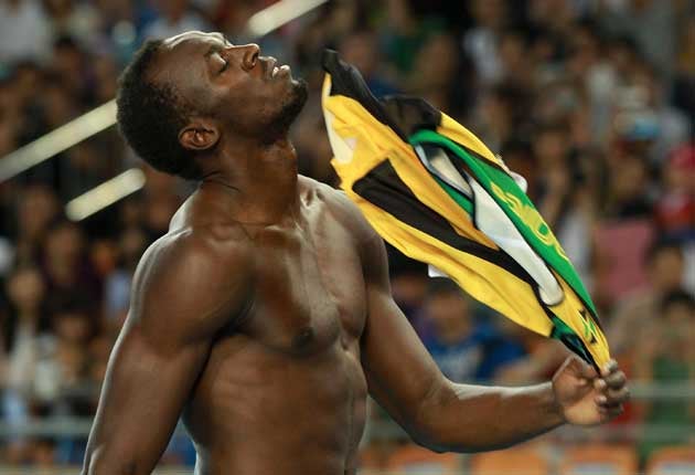 Usain Bolt of Jamaica reacts after false starting in the Men's 100 metre final