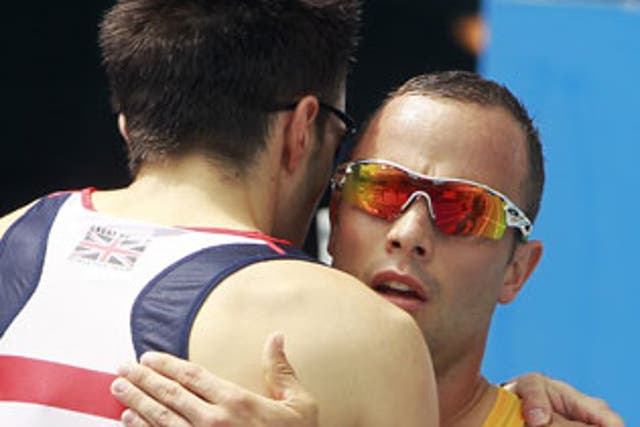 Martyn Rooney (left) and Oscar Pistorius were training together just weeks before the shooting