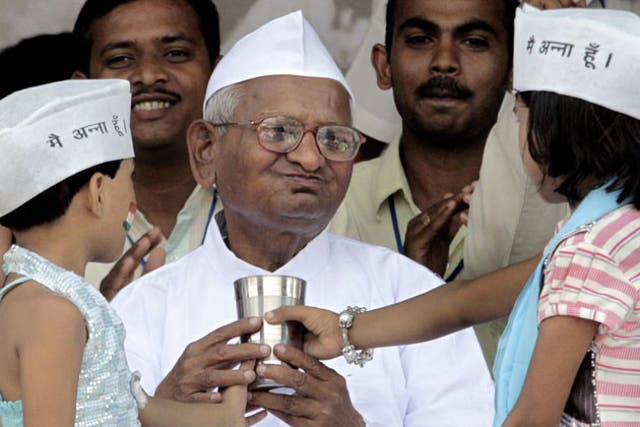 The anti-corruption crusader, Anna Hazare, breaking his fast in Delhi